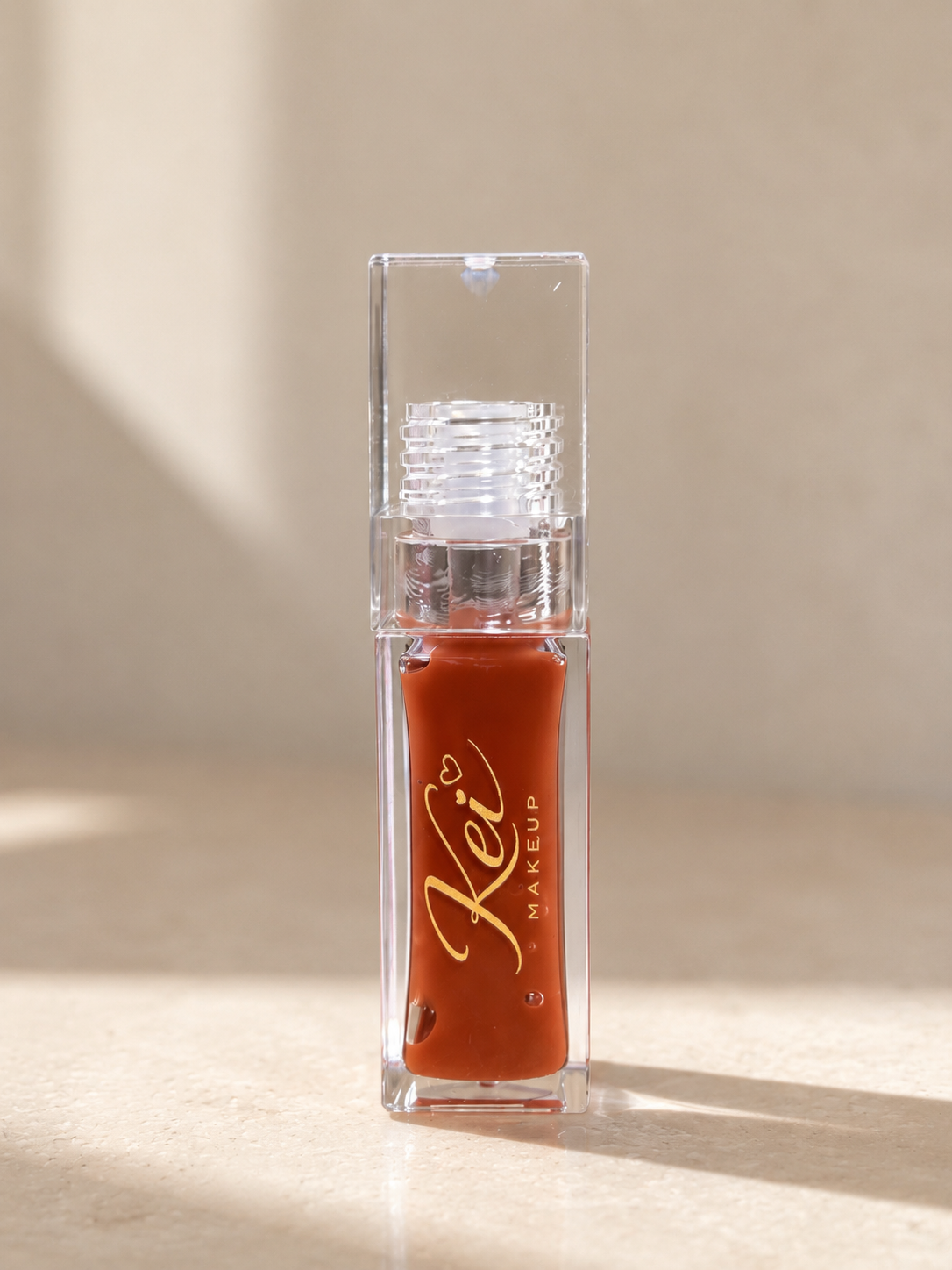 Toffee Drip brown lip gloss by KEI Makeup
